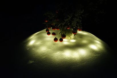 Jäälyhdystä tehty maljakko, johon on laitettu kuusen havuja ja koristeltu joulupalloilla kuin omenia. Jouluvalot olen asettanut lumen alle, katiskaverkkoa hyväksi käyttäen. Joka joulu joku uusi idea.